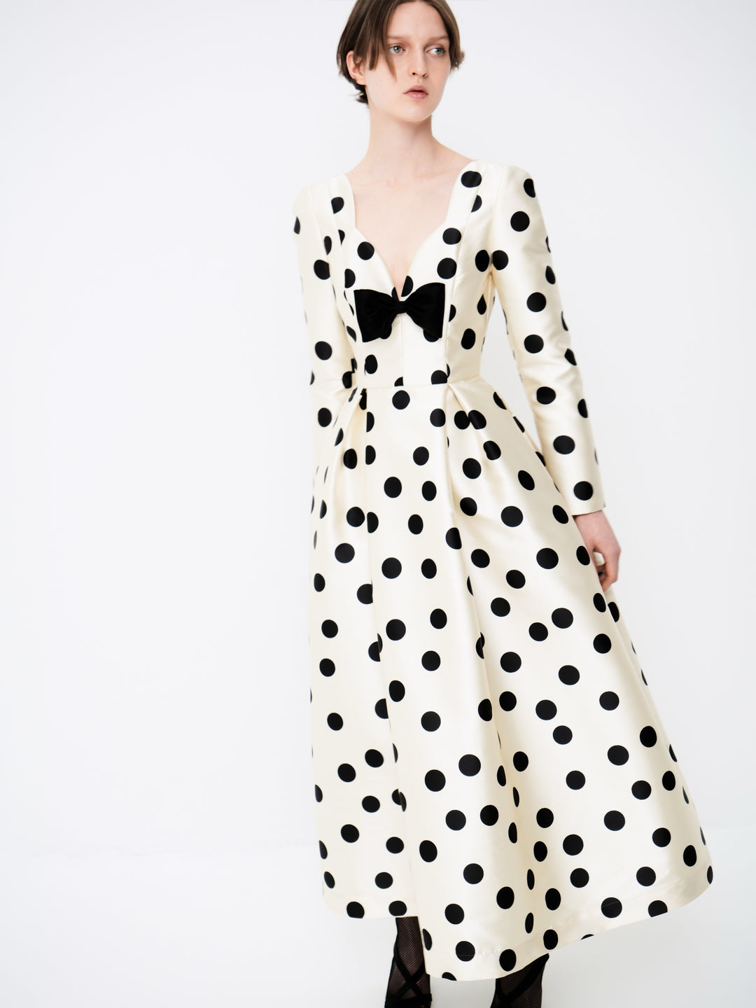 Polka-dot dress with a sculptural neckline and bow