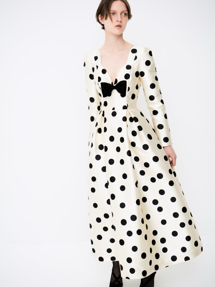 Polka-dot dress with a sculptural neckline and bow