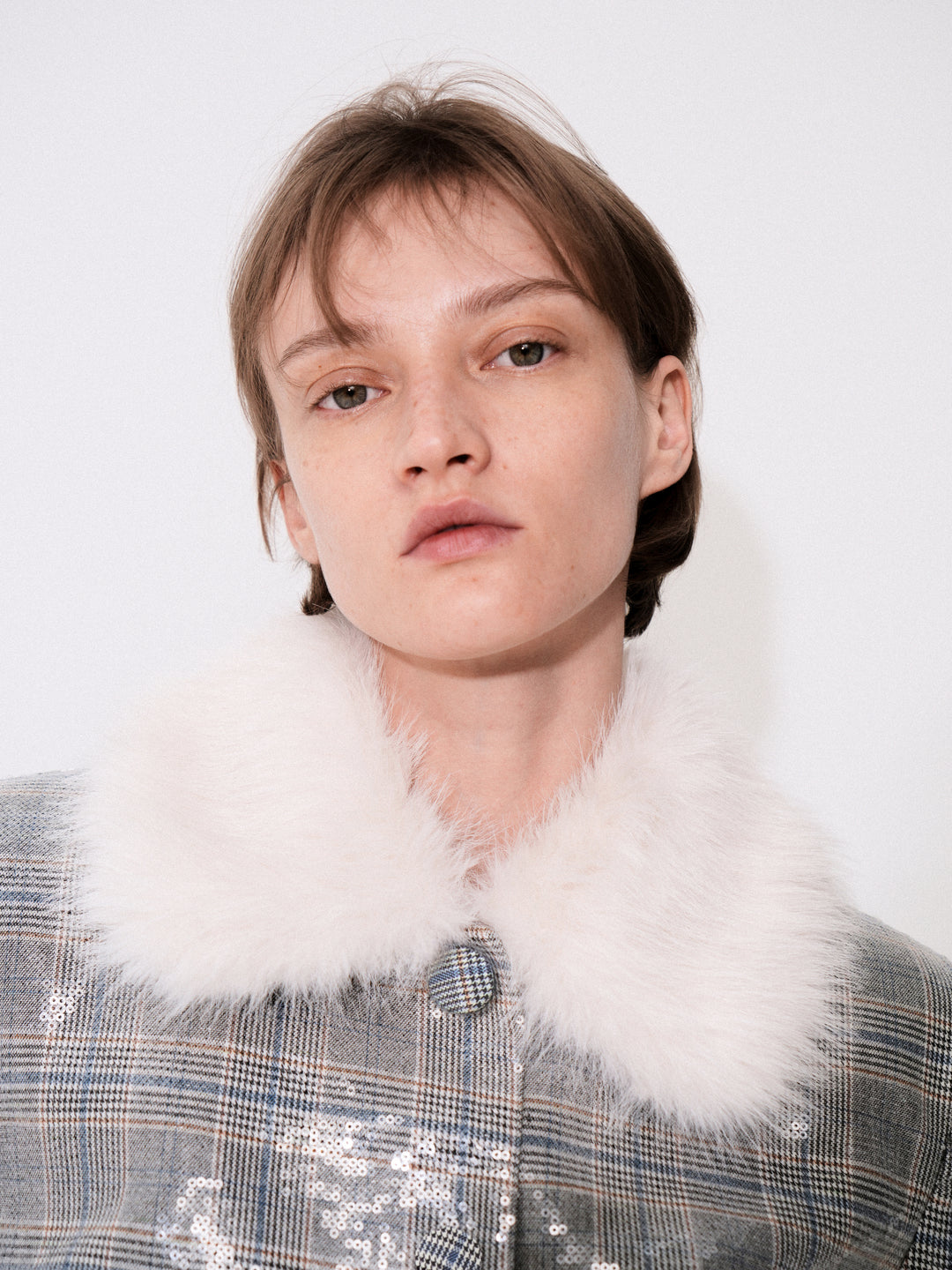 Suiting-fabric jacket with a faux fur collar embellished with transparent sequins