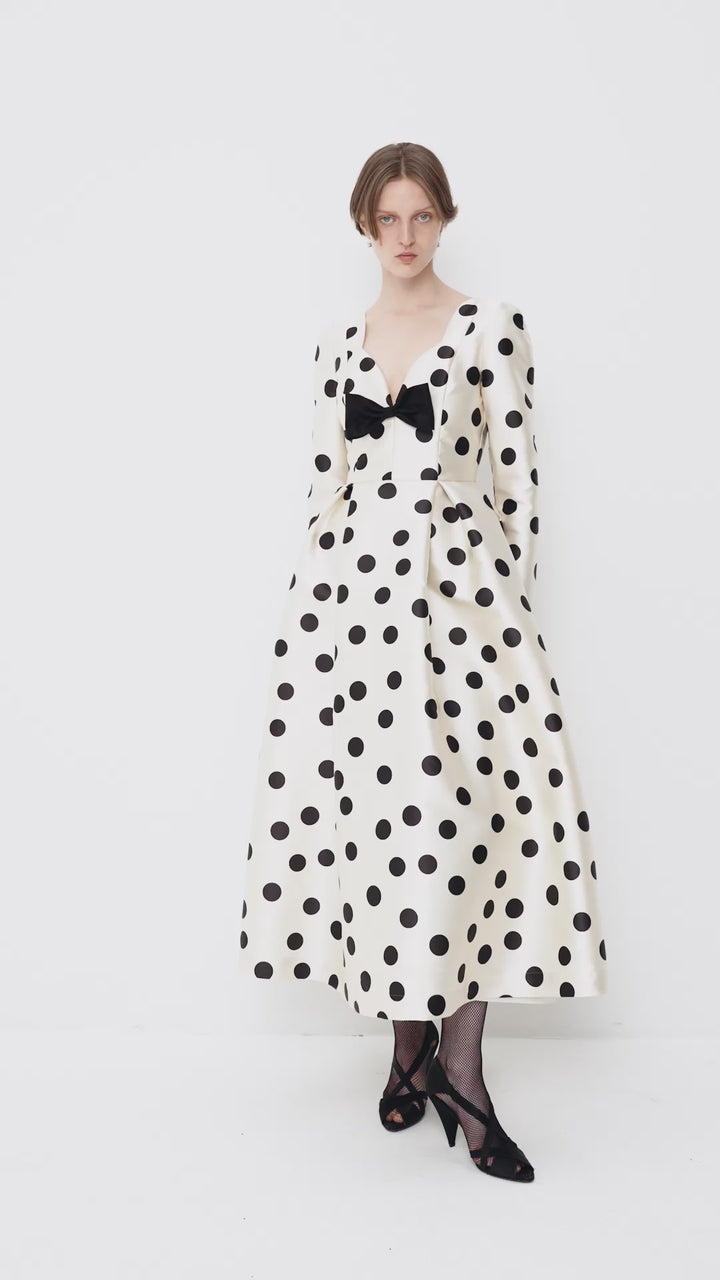 Polka-dot dress with a sculptural neckline and bow
